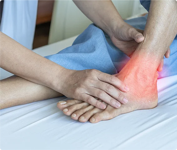 doctor treating a patient with red highlighted ankle