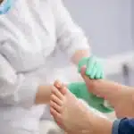 Podiatrist examining patient heel pain and plantar fasciitis at Victoria Foot and Ankle Center
