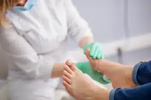 Podiatrist examining patient heel pain and plantar fasciitis at Victoria Foot and Ankle Center