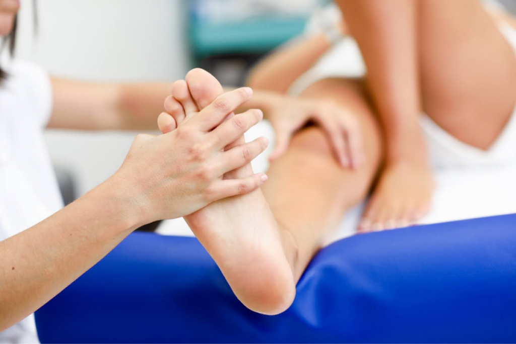 Healthcare practitioner providing foot therapy to a patient, addressing pain or sensitivity.