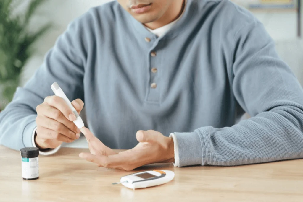 Person using a lancet to test blood sugar levels, a key aspect of managing diabetes-related neuropathy.