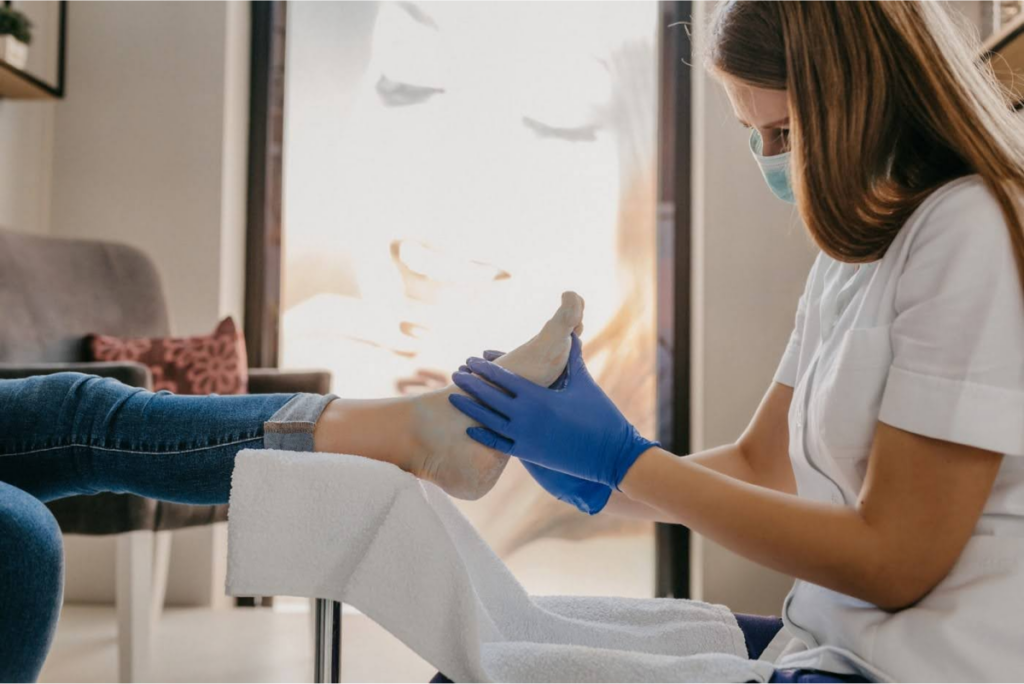 Podiatrist treating a patient's foot during a toenail fungus consultation.