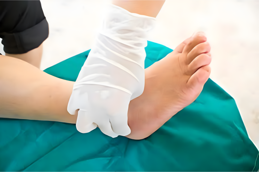 Medical professional examining a foot wearing gloves.