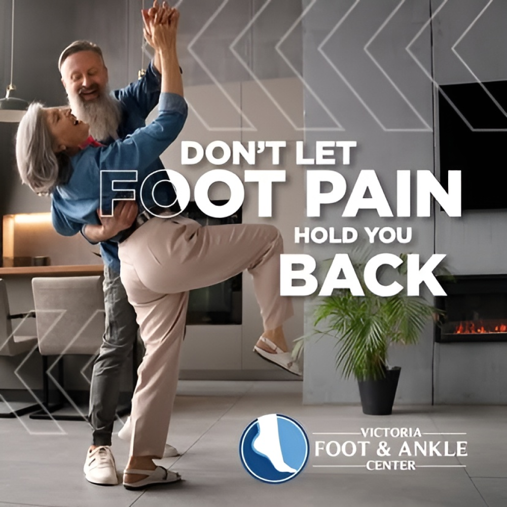 A smiling couple dancing in a modern living room with the text "Don't let foot pain hold you back."