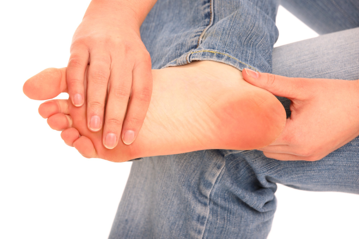 A person sitting an holding his foot