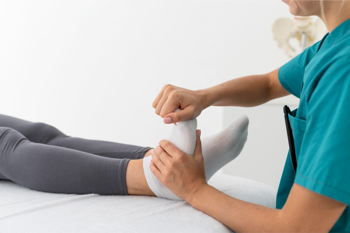 A nurse massaging foot of a patient