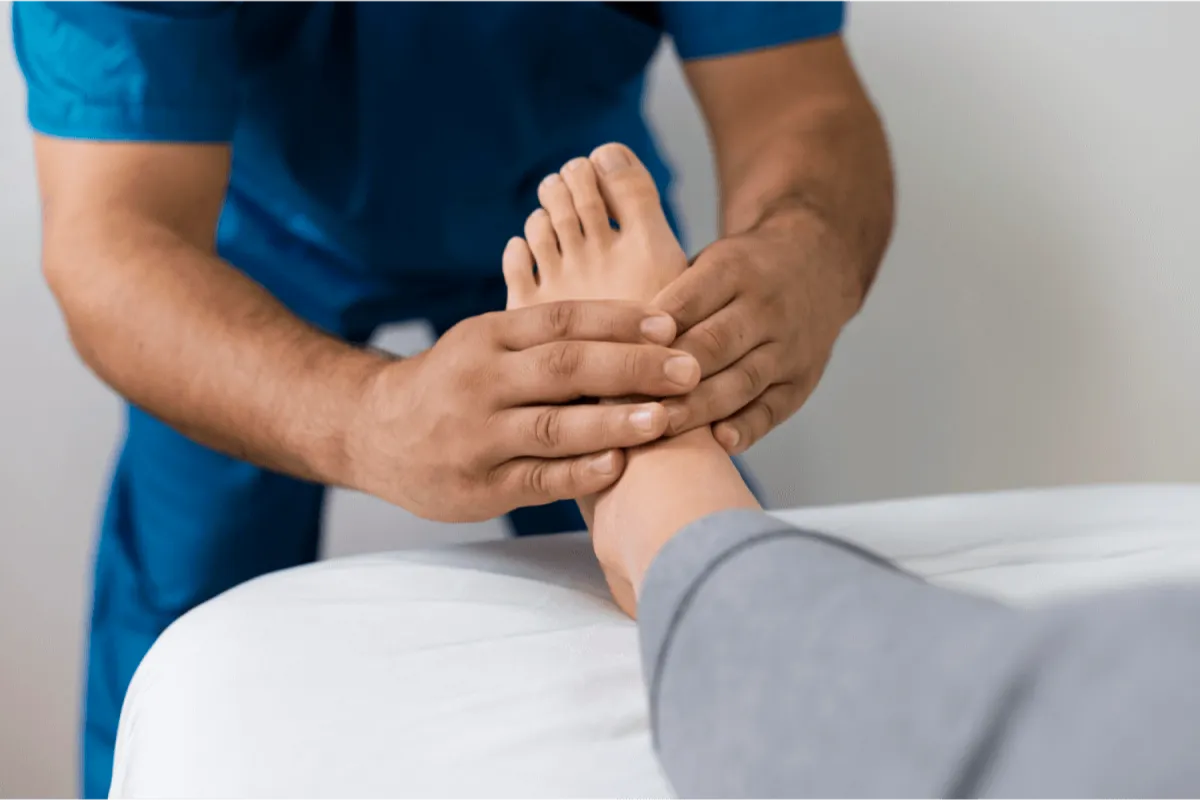 A nurse doing inspection of a foot