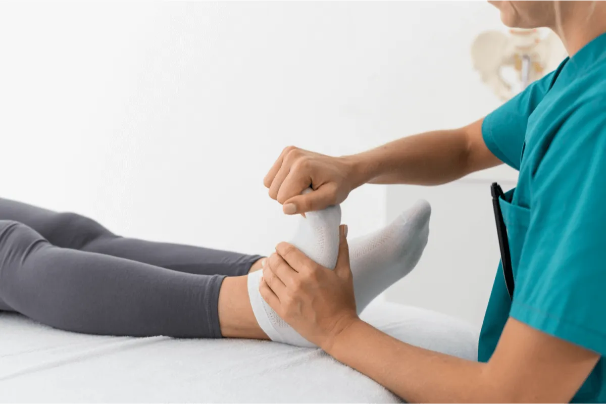 A nurse massaging foot of a patient